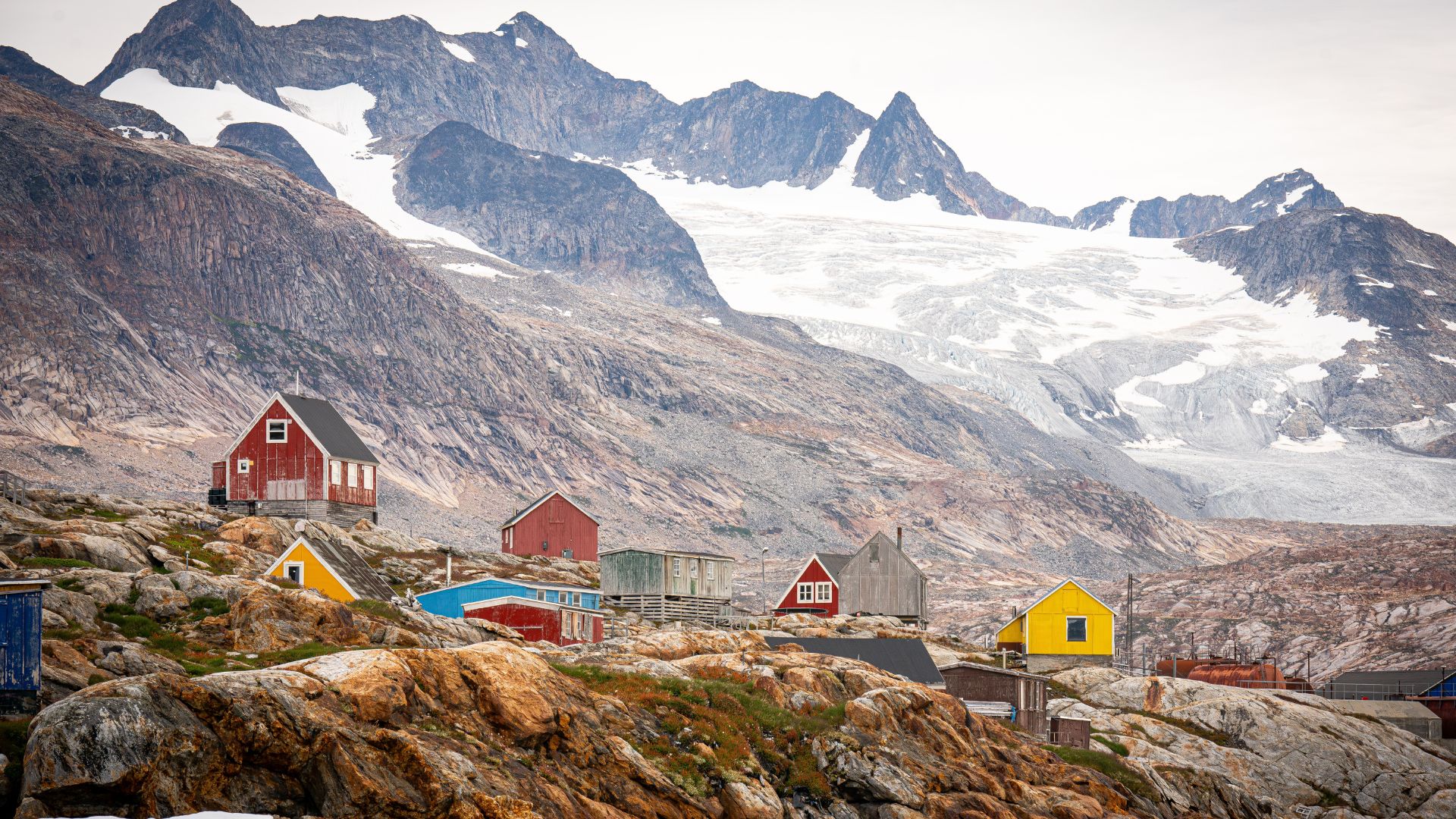 Town in Greenland with mountains in background